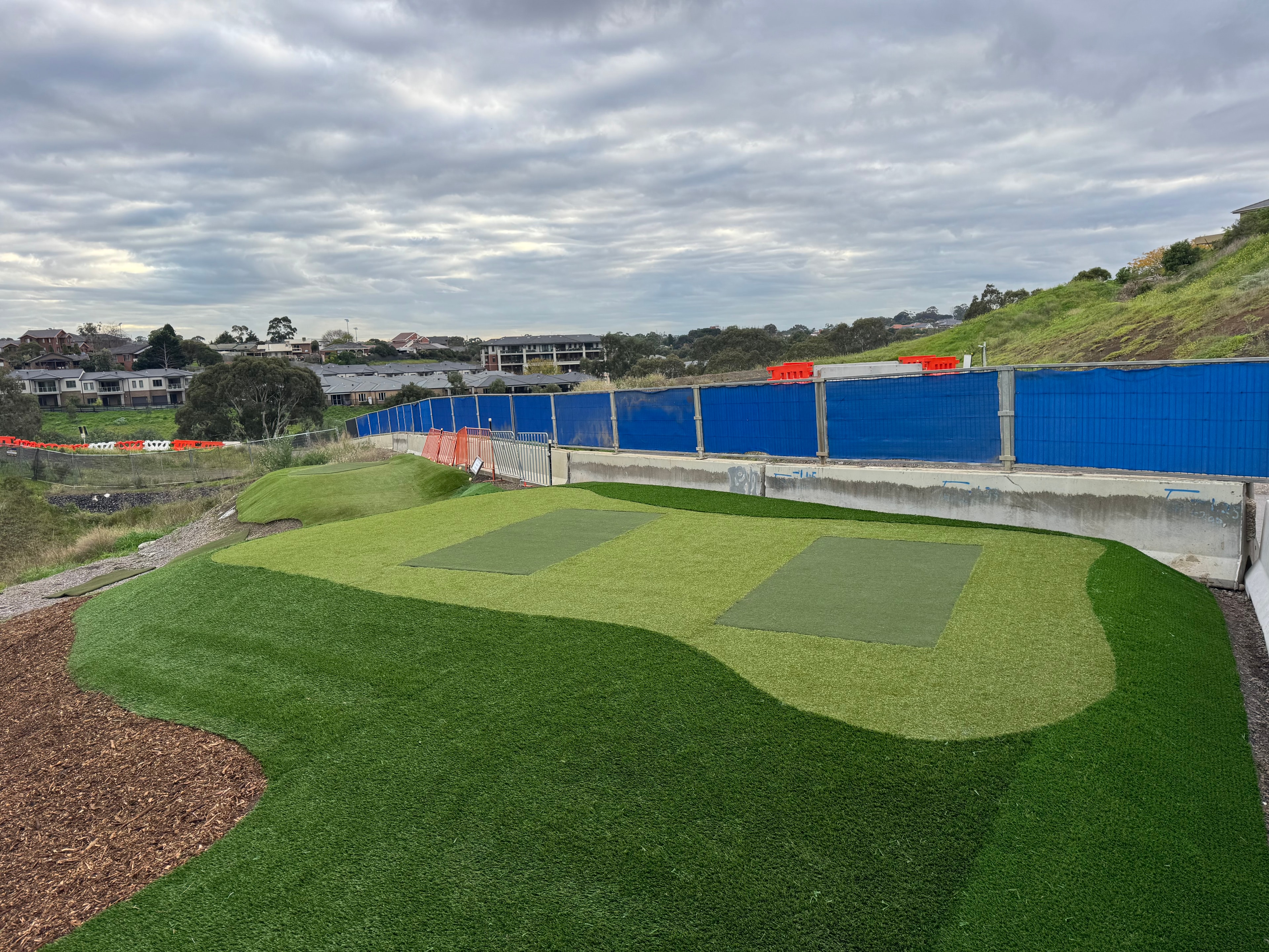 Large putting green installation with sand bunker